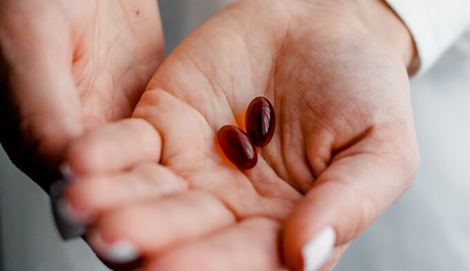 Hands holding pharmaceutical pills